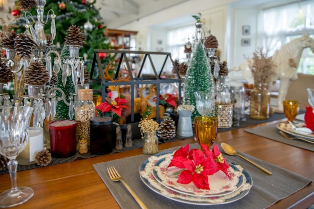 Christmas dinner table setup with decoration, focus selective.