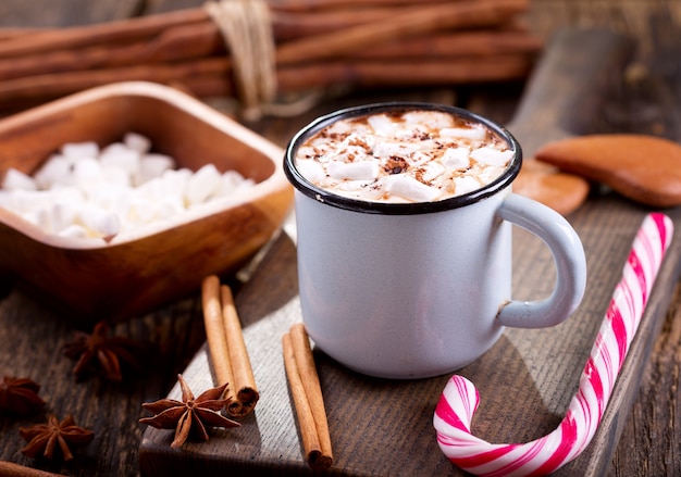 Christmas drink. Cup of hot chocolate with marshmallows on wooden table