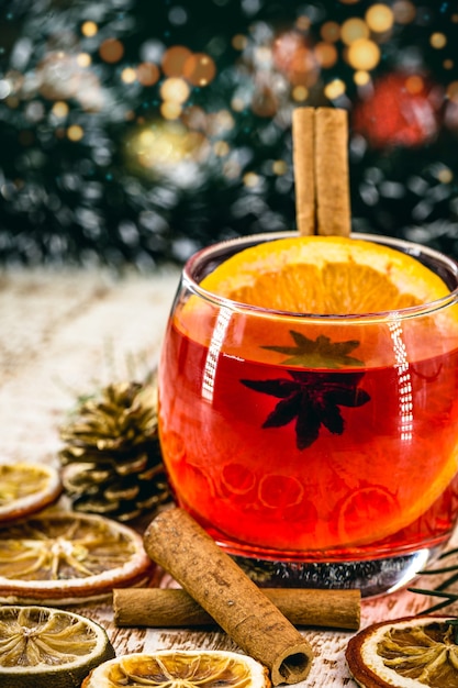 Christmas drink sangria or mulled wine, or bray, with apples, oranges, pomegranate and cinnamon sticks.