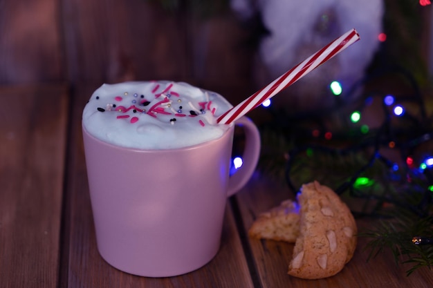 Christmas drink with homemade cookies on a wooden table