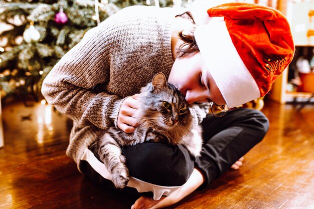 Christmas eve, pre-holiday card of teenager with pet