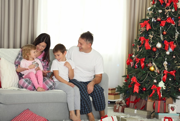 Christmas family portrait in home holiday living room, at morning