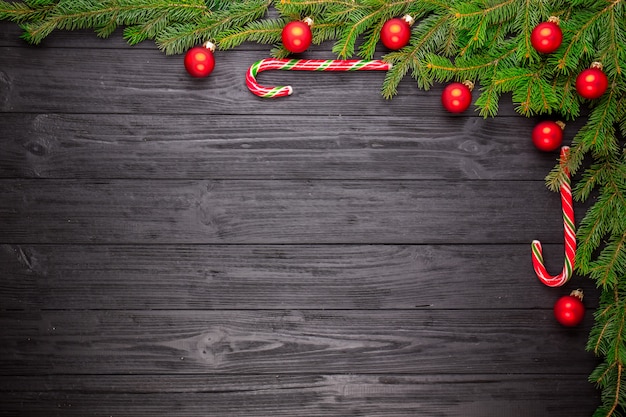 Christmas fir tree on black wooden background