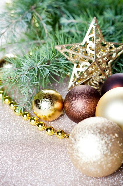 Christmas fir tree branch, golden star, brown balls.