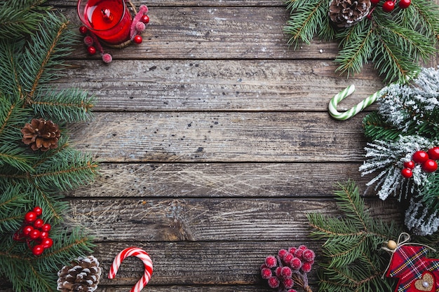 Christmas fir tree with decoration on dark wooden board