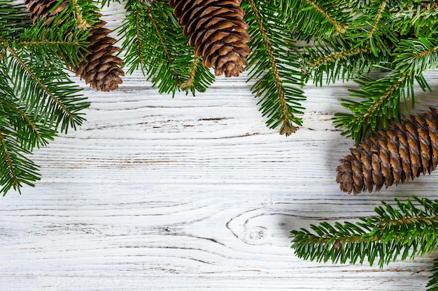 christmas fir tree with pinecones on a wooden board