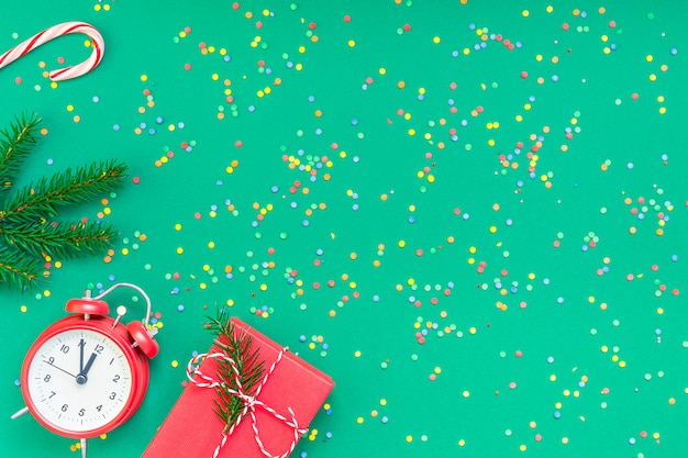 Christmas flat lay with red alarm clock