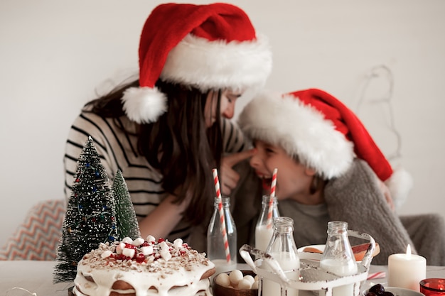 Christmas food. Happy family mother and son hug and laugh at the holiday table.