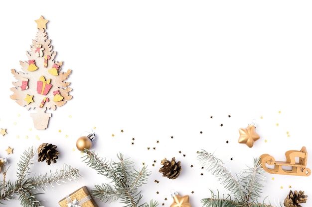 Christmas frame made of fir branches, cones, gold stars and decorations. Christmas wallpaper. 2020 background isolated on white. Flat lay, top view, copy space