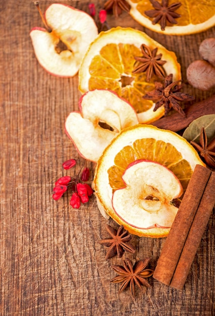 Christmas frame Spices and dried orange sliceson on a wooden table