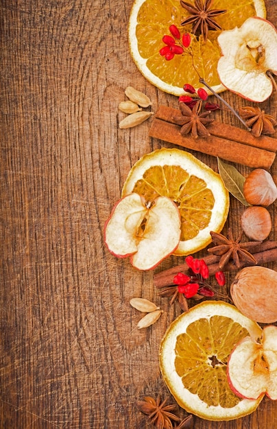 Christmas frame Spices and dried orange sliceson on a wooden table