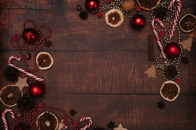 Christmas frame, in the style of flatley with Christmas decorations made of balls, cones, spices. The concept of celebrating the New Year. Top view.