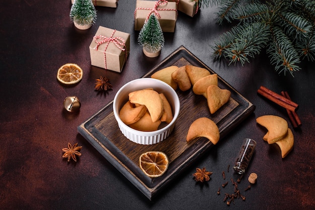 Christmas frame with fir tree branches, gingerbread cookies, spices and dried orange rings