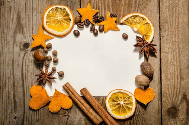 Christmas Frame with nuts, spices and oranges. Flat lay. Top view