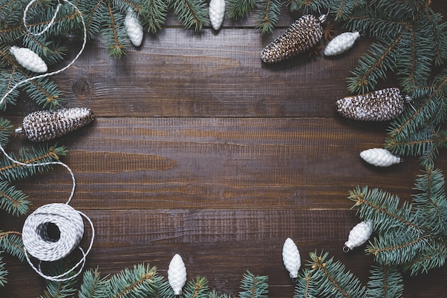 Christmas frame with white ornaments on wooden board