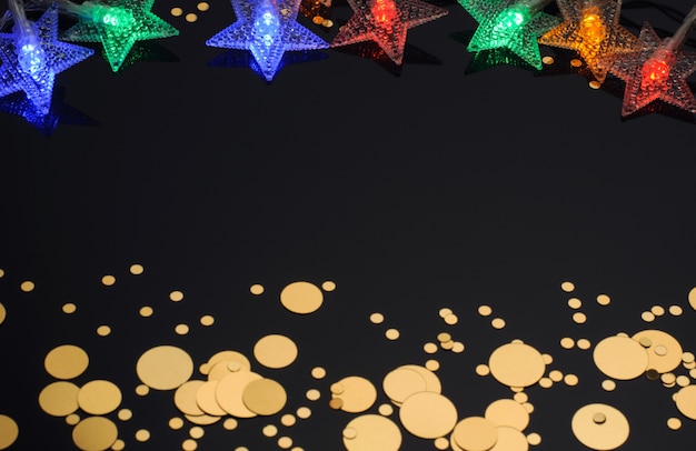 Christmas garland in the form of stars golden confetti on a black background Christmas Decoration