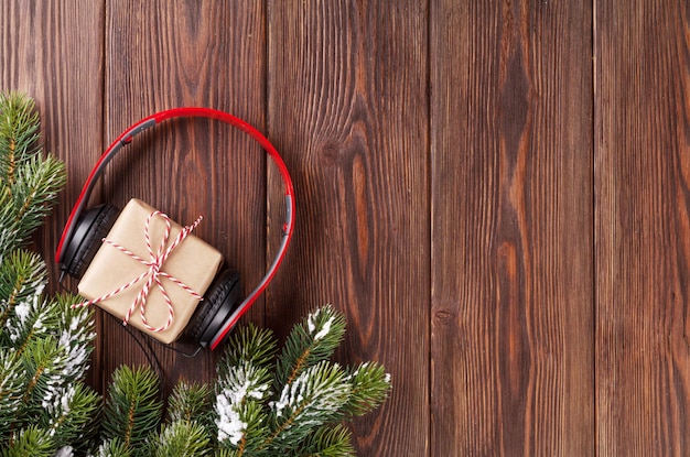 Christmas gift box with headphones and tree branch