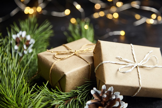 Christmas gift box with light garland on dark background