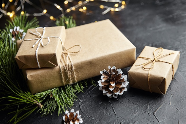 Christmas gift box with light garland on dark background