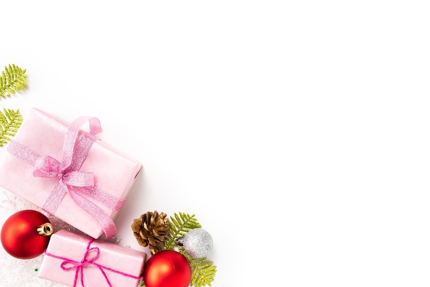  Christmas gift box with red ball and pine cones on white background.