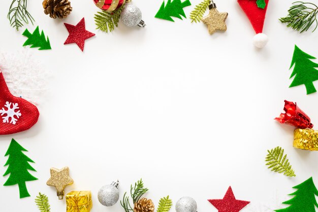 Christmas gift box with red ball and pine cones on white background.