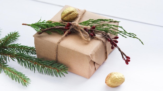 Christmas gift boxes and fir tree branch on wooden table Shristmas background