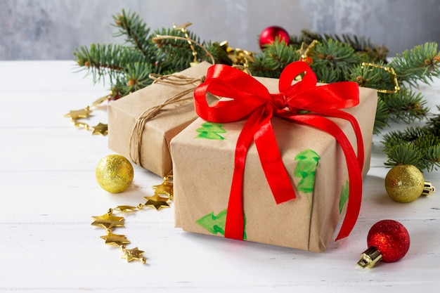 Christmas gift boxes with a Christmas tree on a white wooden table