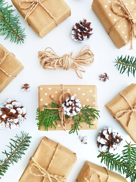 Christmas gift boxes wrapped in craft paper hand made gifts decorated with fir branches and pine