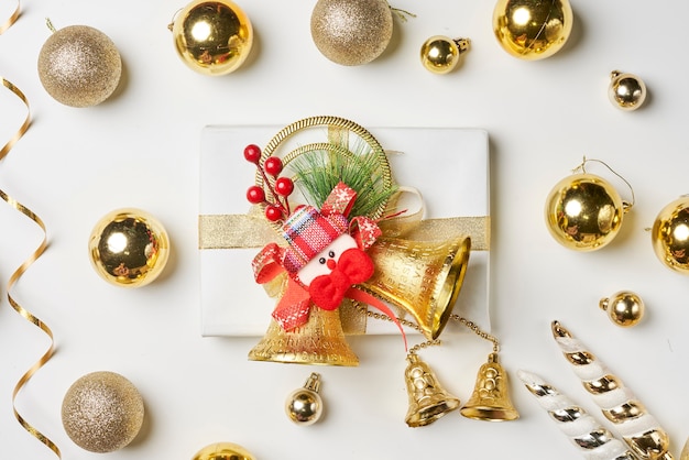 Christmas gift and festive baubles on white background