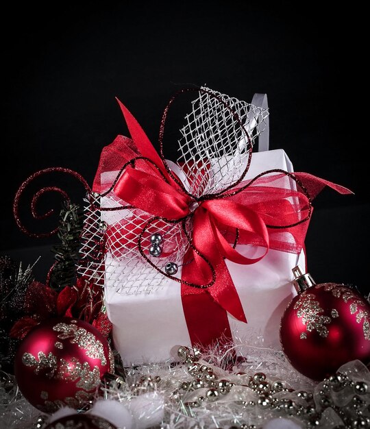 Christmas gift and red Christmas balls on a black background