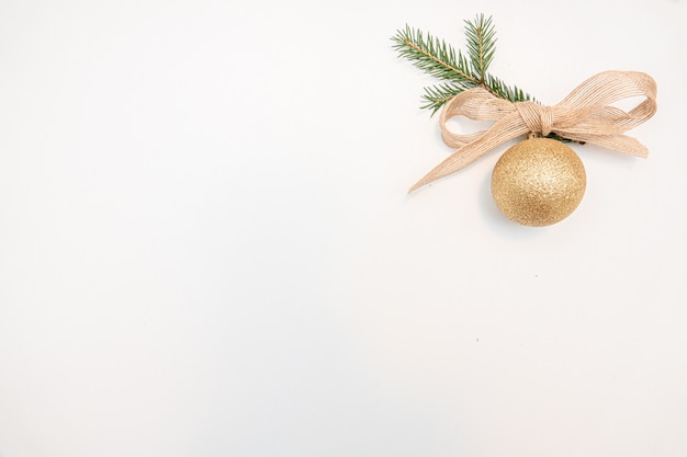 Christmas gift with gold balls bow isolated on white background