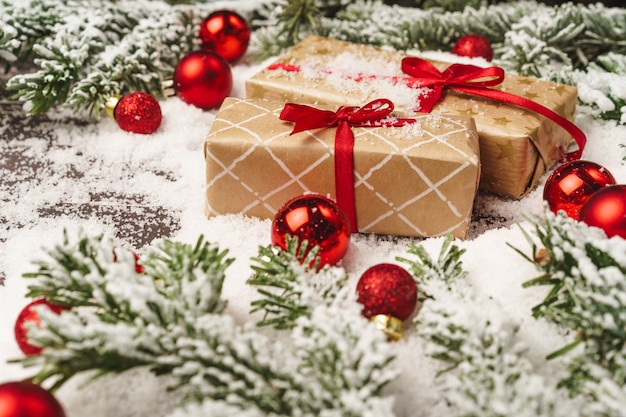 Christmas gift on wooden table powdered with snow