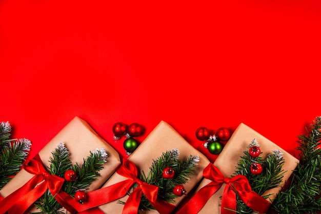 Christmas gifts in craft paper on a red background Top view with copy space Celebrating Christmas and New Years