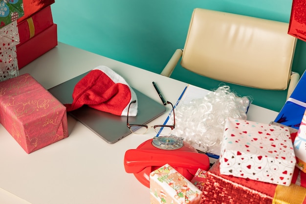 Christmas gifts lie on the table in modern santa's office