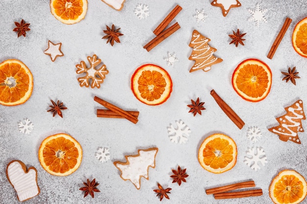 Christmas ginger cookies dried orange cinnamon star anise and snowflakes on gray stone background