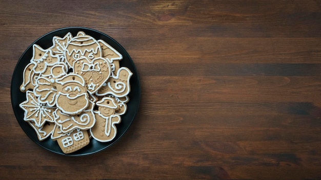 Christmas gingerbread cookies on dark plate