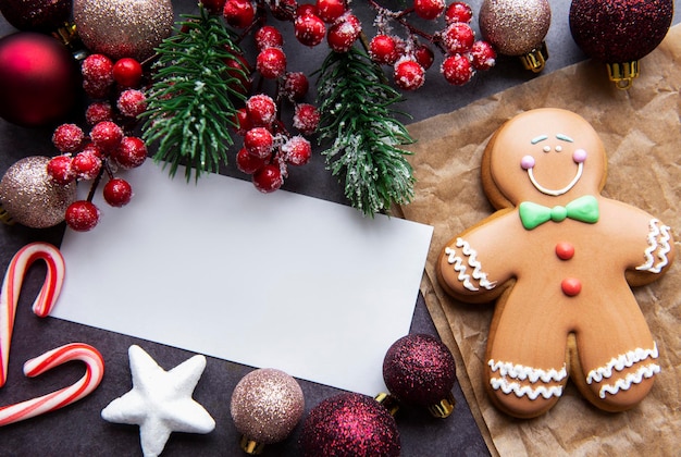 Christmas gingerbread cookies and greeting card on a dark background.  Homemade delicious Christmas gingerbread