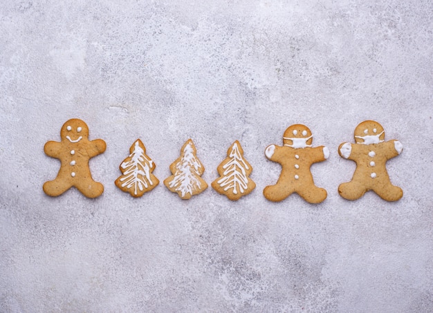 Christmas gingerbread cookies man in face masks. Social distance concept