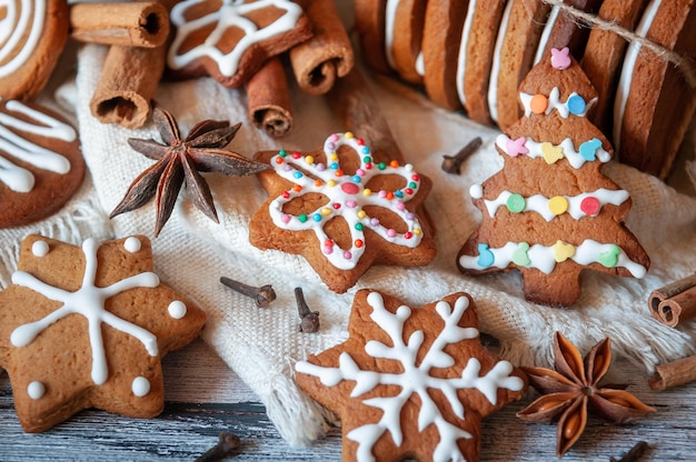 Christmas gingerbread Decorated with white icing in topping On wooden gray background In a rustic style Closeup