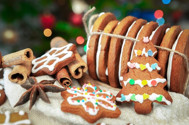 Christmas gingerbread Decorated with white icing in topping On wooden gray background In a rustic style Closeup