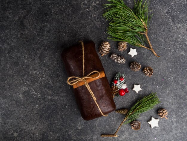 Christmas gingerbread dough on grey background Cones wooden stars green branch berrries cinnamon stick Christmas New Year card Atmospheric stylish image winter holidays