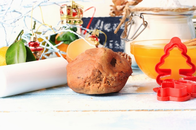 Christmas gingerbread dough for homemade cakes on a light wooden background selective soft focus rustic style