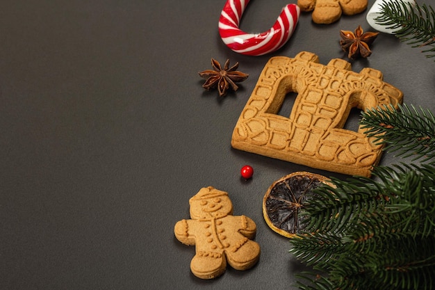 Christmas Gingerbread House cookies biscuit. Traditional festive New Year decor. Black stone concrete background, lifestyle, flat lay, copy space