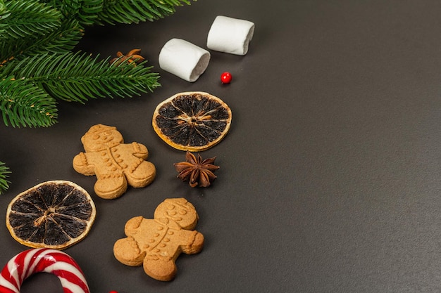 Christmas Gingerbread House cookies biscuit. Traditional festive New Year decor. Black stone concrete background, lifestyle, flat lay, copy space