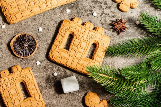 Christmas Gingerbread House and Gingerbread Men. Traditional festive New Year design, cooking process. Modern hard light, dark shadow, flat lay, top view