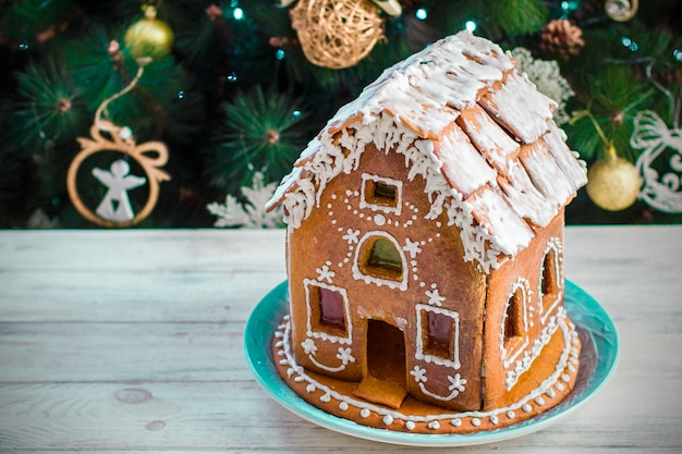 Christmas Gingerbread House with glaze On Wooden Table