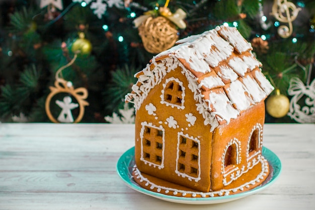 Christmas Gingerbread House with glaze On Wooden Table