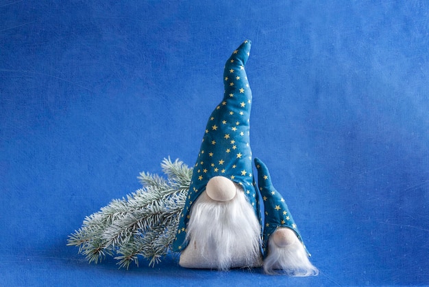 Christmas gnome Gonk wearing a blue hat with long beard. New year and Christmas greeting card design