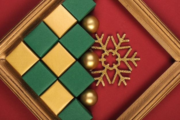 Christmas gold and green decorations on red background