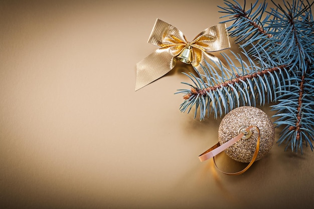 Christmas golden ball bow fir branch holidays concept